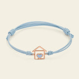 Cord bracelet with house and light blue enameled heart