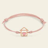 Cord bracelet with house and pink enameled heart