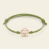 Cord bracelet with green enameled house and heart